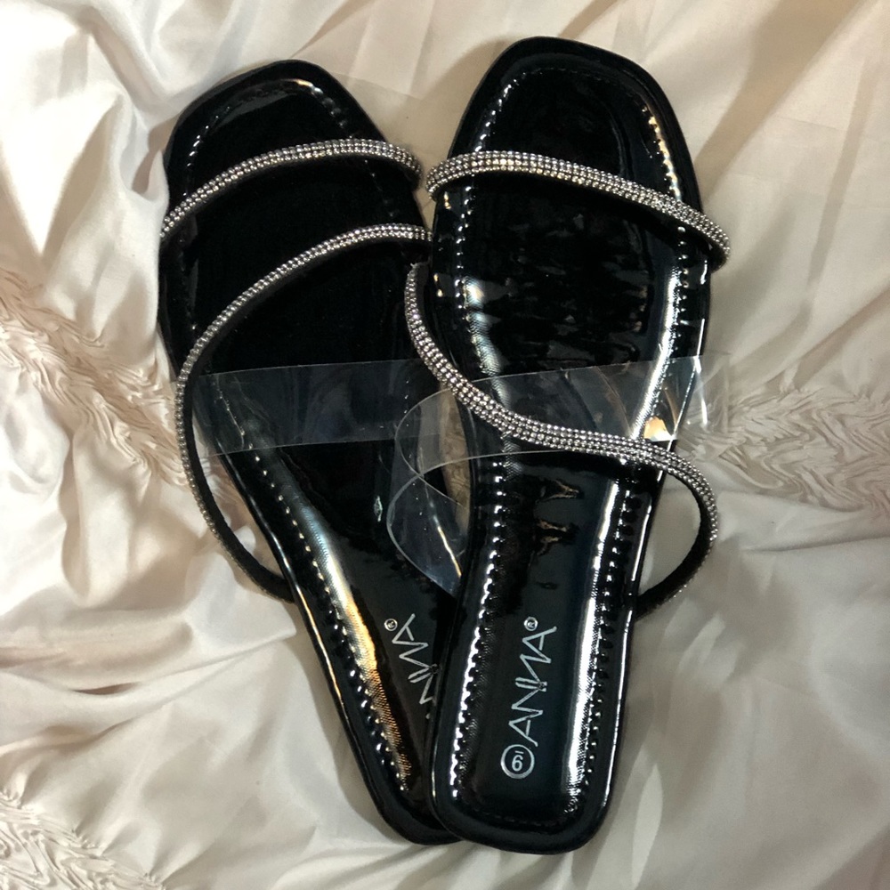 Stylish women’s flat dress up sandals. Silver gems on straps. Worn once. Size 9.